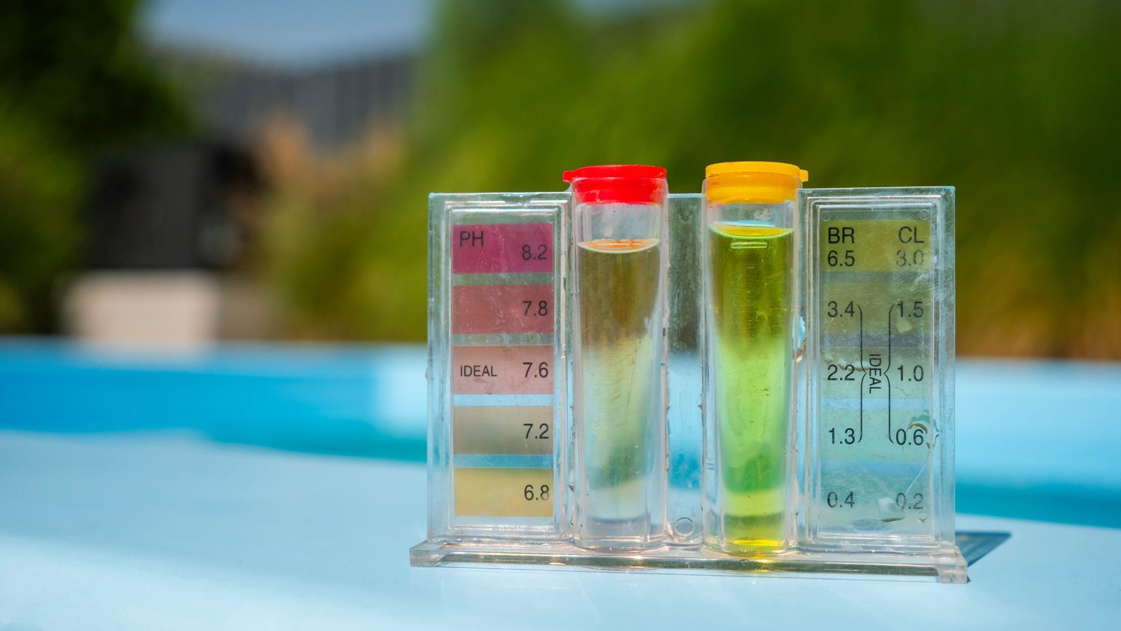 Water testing kit displaying pH and chlorine levels with colour indicators in clear tubes.
